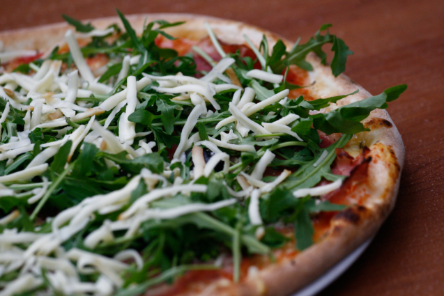 A pizza with dandelion salad served at Pizzeria Rustika in Bled, Slovenia