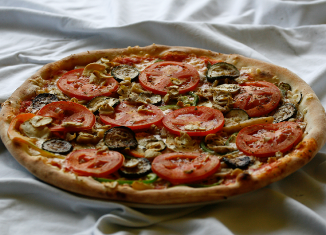 A vegetable pizza with tomatoes served at Pizzeria Rustika in Bled, Slovenia