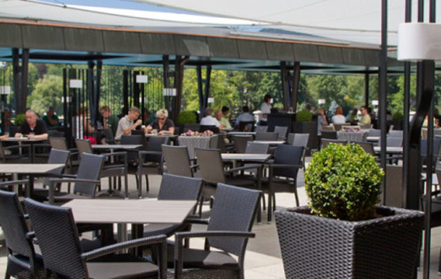 An outside terrace full of customers at Restaurant Cafe Park in Bled