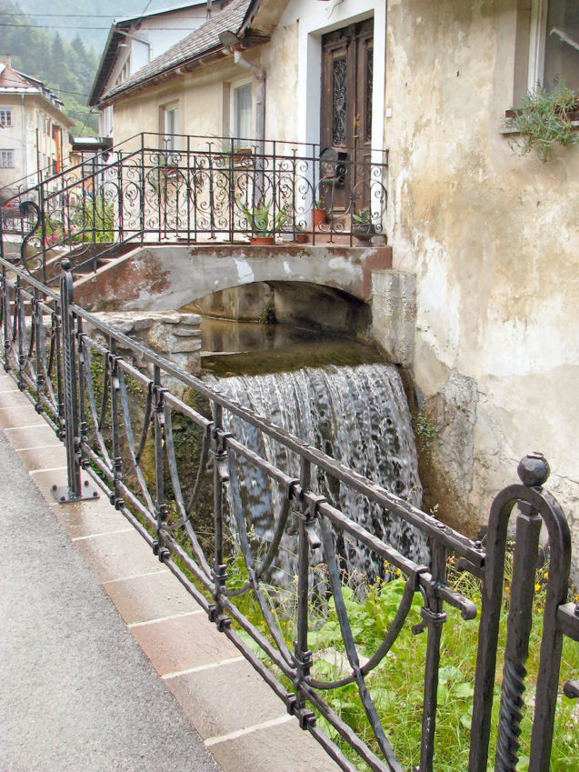 Hand forged grey decorative iron fence in the village of Kropa, Slovenia