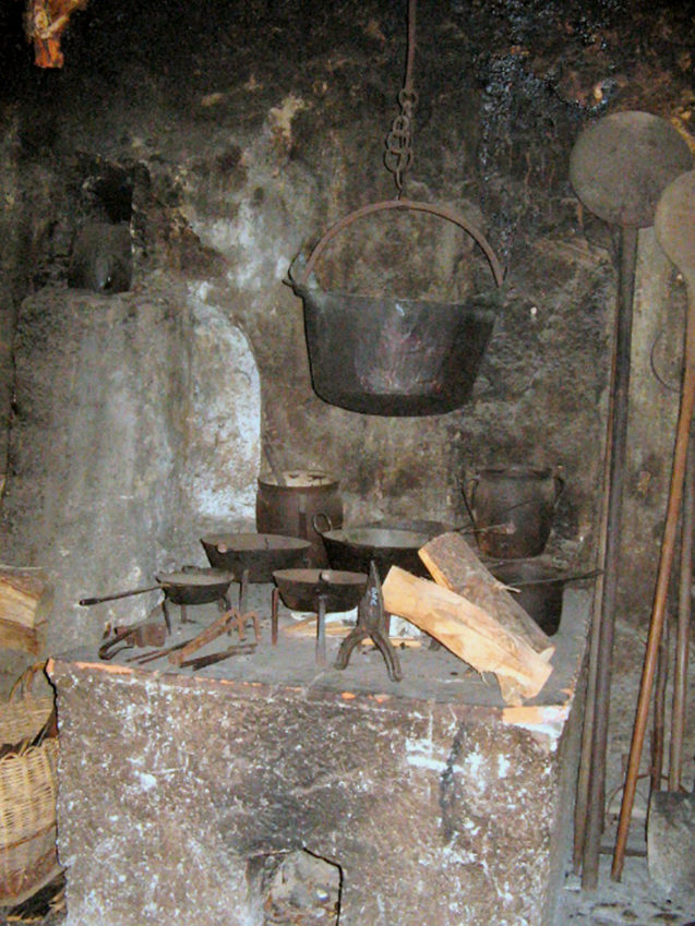 A smoke-stained black kitchen inside Liznjek House in Kranjska Gora