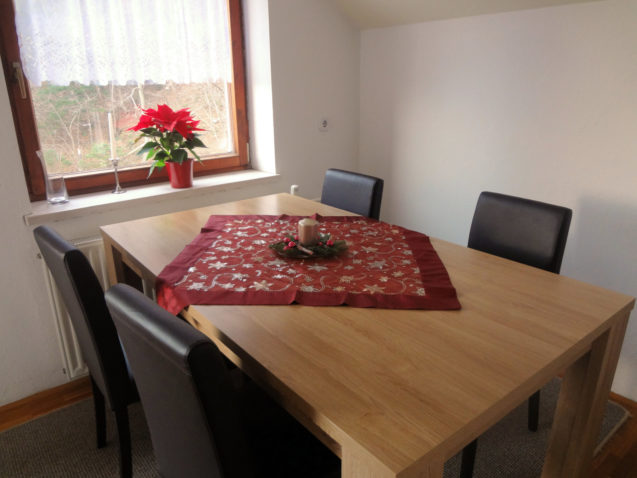 Holiday decorations and a poinsettia in the dinning area of the Fine Stay Apartment in Slovenia