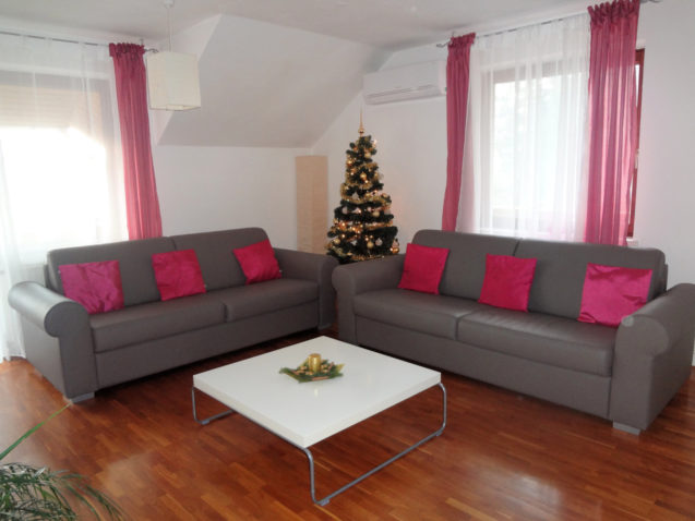 A Christmas tree with lights in the Fine Stay Apartment in Slovenia
