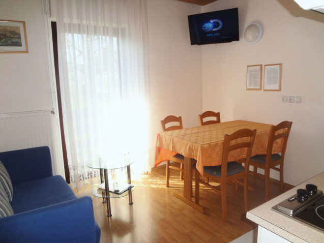 Dinning table and flat screen TV in the Fine Stay Apartments in Lake Bled, Slovenia