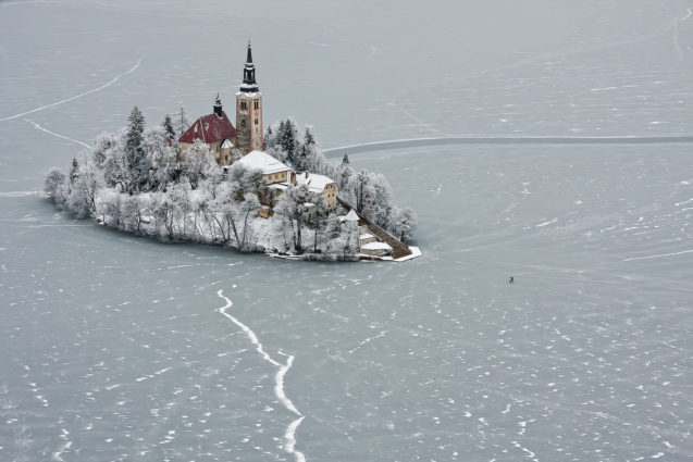 Frozen Lake Bled and its island with a church in winter, Slovenia