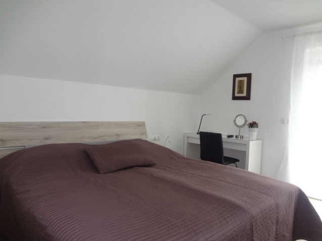 A king size double bed and a work desk in the first bedroom of the Fine Stay Apartment, Bled Area Of Slovenia