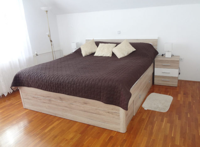 A king-size double bed in Apartments Fine Stay