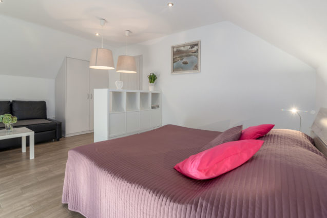 A large double bed in the first bedroom of Modern Apartment With Balcony, Apartments Fine Stay