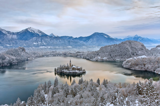 A view of Lake Bled with a layer of snow in the winter