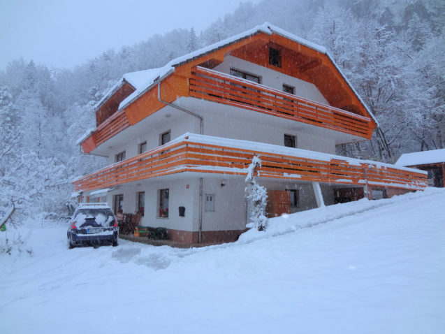 Exterior of Fine Stay Apartments in the Bled area of Slovenia in winter during snowfall