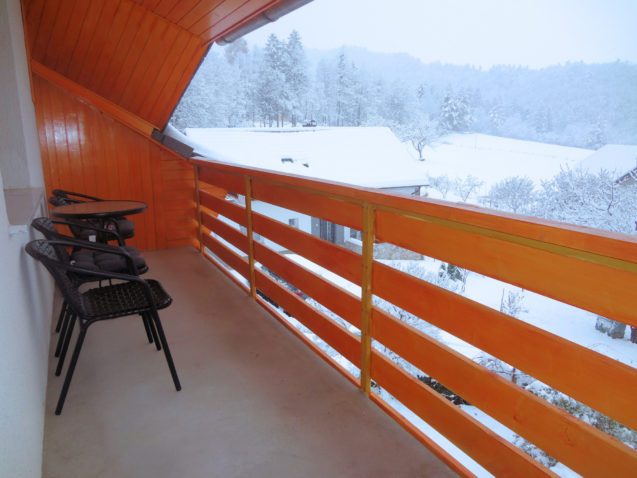 A view from the second balcony of the Superior Apartment the snow-covered orchard in the winter