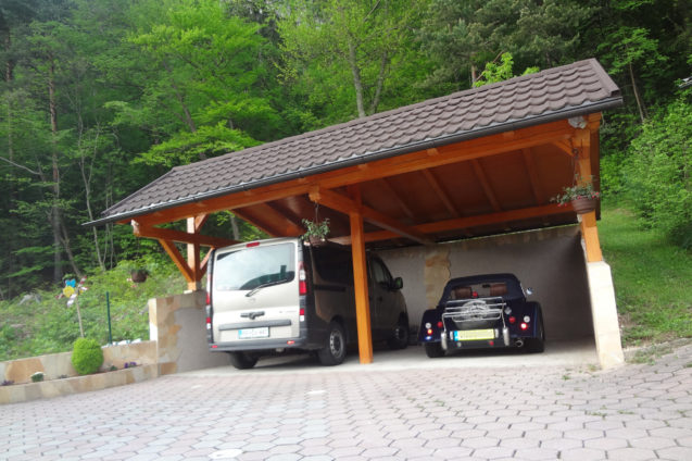 A classic British sports car Morgan Roadster parked in a carport at Fine Stay Apartments in Slovenia