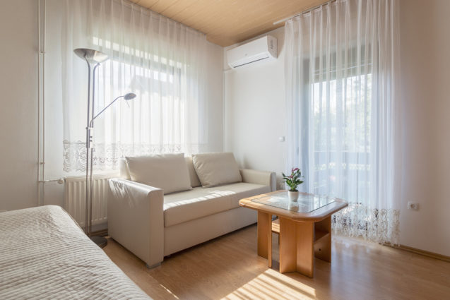 A three-seater-sofa and an air-con at the accommodation Apartments Fine Stay Bled