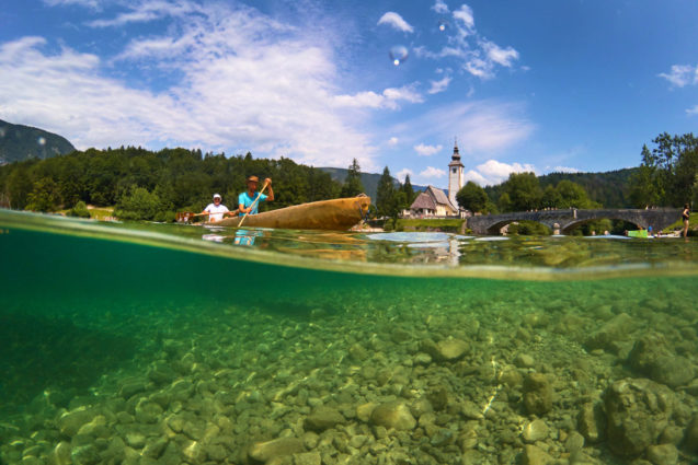 Canoeing at Lake Bohinj in summer with the church in the background