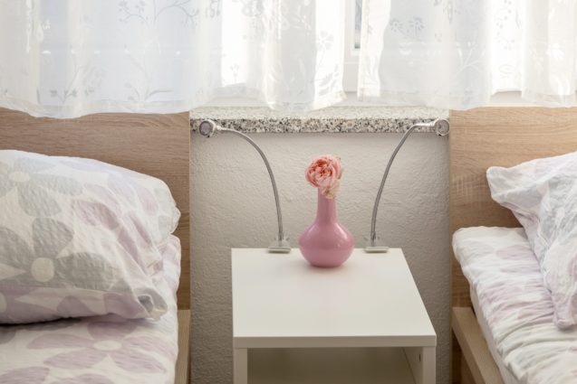A nightstand with two lamps in the second bedroom of the Modern Apartment With Balcony and Terrace