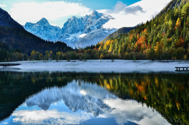 Lake Jasna near Kranjska Gora in autumn with mountains of Slovenian Alps in the background