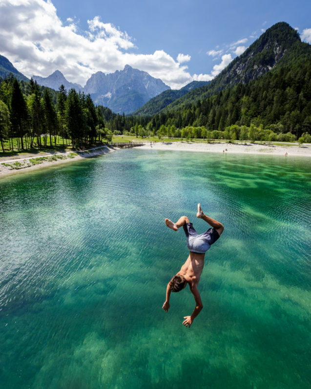 A man taking a dive at Lake Jasna in Kranjska Gora, Slovenia
