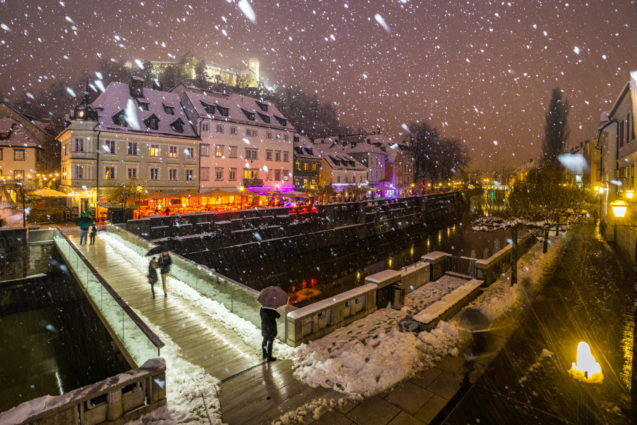 Ljubljana Old Town in winter at night during snowfall