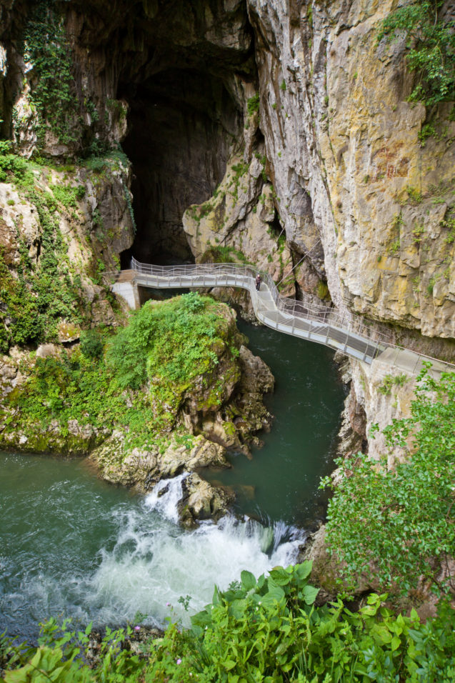 A bridge over River Reka leading to the entrance of Skocjan Caves