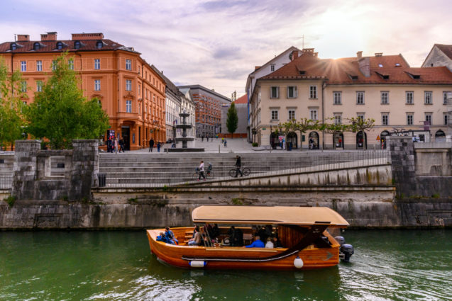 A tourist boat in the Ljubljanica River in Ljubljana, the capital city of Slovenia