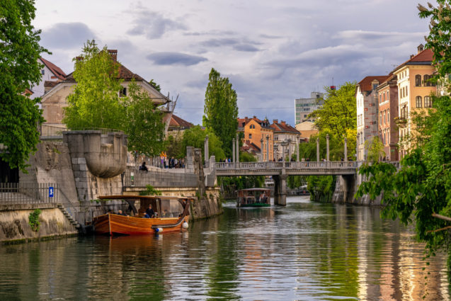 A tourist boat cruising the Ljubljanica River in Ljubljana, the capital city of Slovenia