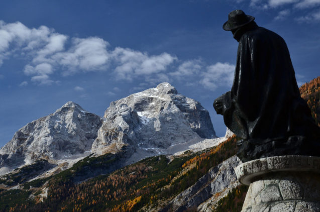 Bronze figure of Dr. Julius Kugy, explorer of the Julian Alps, gazes towards Mt. Jalovec above Trenta Valley