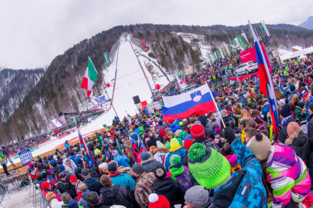 Spectators with Slovenian flags during the ski flying competition in Planica, Slovenia
