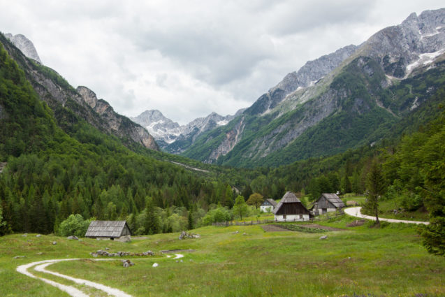 Farms in Trenta Valley with mountains of Slovenian Alps in the background