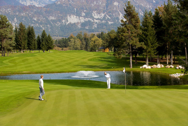 A couple playing golf at Royal Bled Golf course in Slovenia