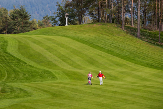 A couple walking at Royal Bled Golf course in Slovenia