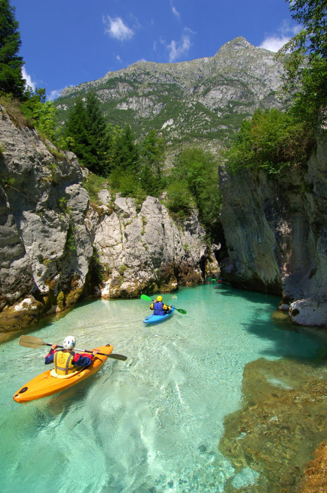 A group of kayakers on the Soca River in Slovenia