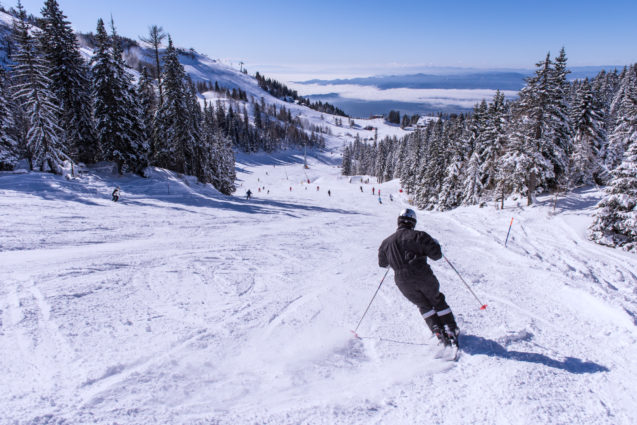 A skier skiing down the slopes at Krvavec Ski Resort