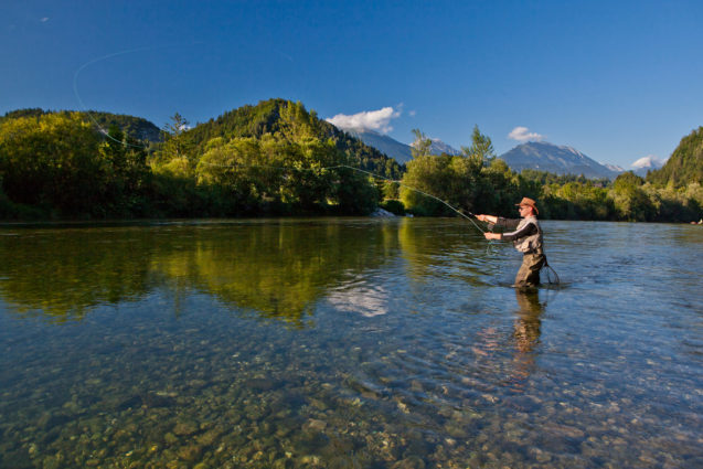 A fisherman flyfishing in River Sava in northwestern Slovenia