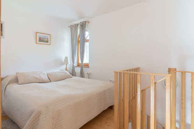 Queen size double bed in the bedroom of Duplex Apartment with Balcony at Apartments Valant Bled in Slovenia