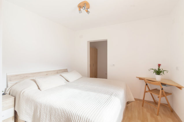 King size double bed in the bedroom of Cosy Apartment With Terrace  at Apartments Valant Bled in Slovenia