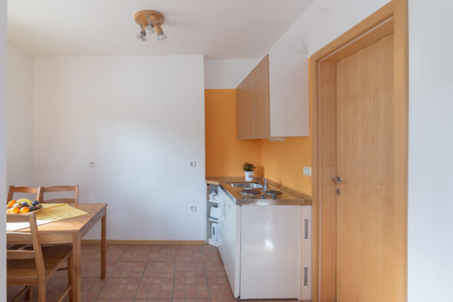 A dining table and kitchenette in Duplex Apartment with Balcony at Apartments Valant Bled in Slovenia