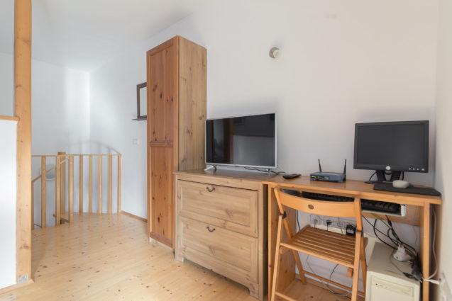 Television and computer in the living room of Duplex Apartment with Balcony at Apartments Valant Bled in Slovenia