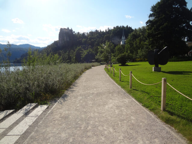Empty path around Lake Bled with a castle in the background