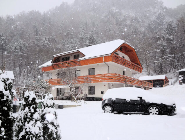 Exterior of Apartments Fine Stay blanketed with a layer of snow as Slovenia received its first snow in winter 2020-21