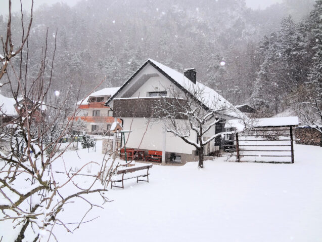 Exterior of Apartments Fine Stay blanketed with a layer of snow as Slovenia received its first snow in winter 2020-21