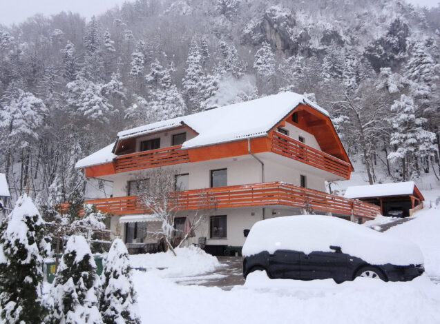 Exterior of Apartments Fine Stay blanketed with a layer of snow as Slovenia received its first snow in winter 2020-21