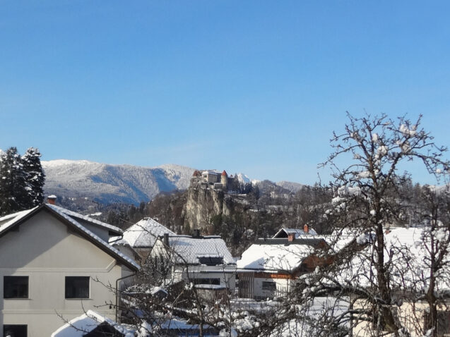 Zoomed-in-view of Bled Castle from the Loft Apartment at accommodation Apartments Fine Stay Bled in Winter