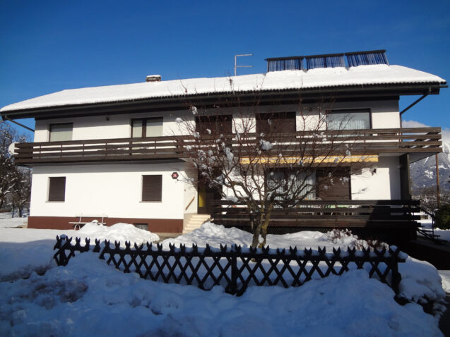 Exterior of Apartments Fine Stay Bled covered in snow in winter
