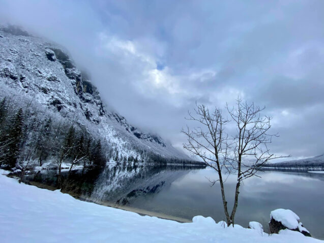 Lake Bohinj covered in snow on a dull winter day