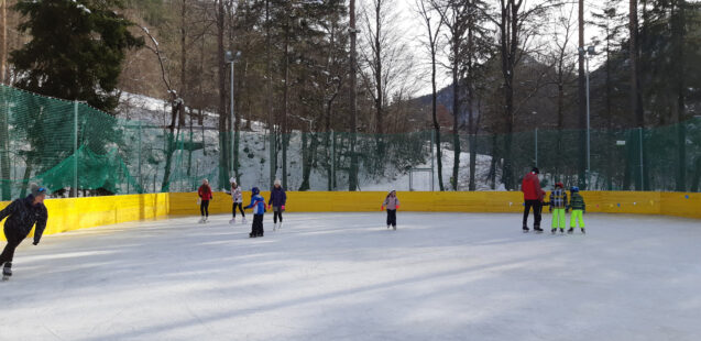A group of people Ice skating at the outdoor ice rink in Zavrsnica