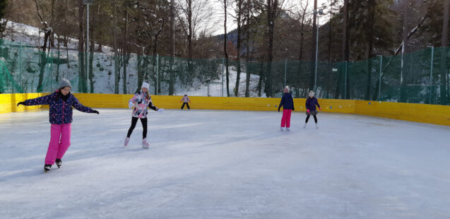 A group of people Ice skating at the outdoor ice rink in Zavrsnica