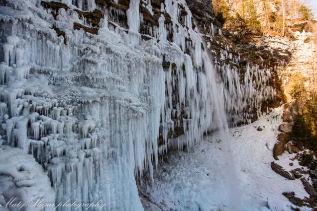 Frozen wall of icicles at Pericnik Waterfall in winter