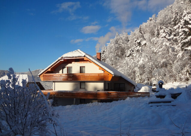 Exterior of accommodation Fine Stay Apartments in Slovenia on a clear day after snowfall