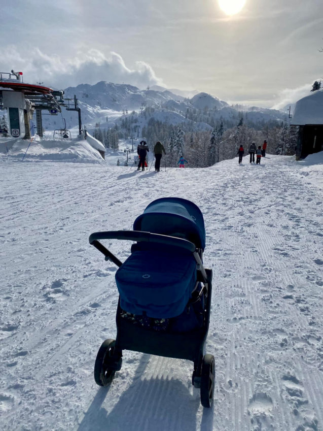 A family with a pushchair at Vogel above Bohinj